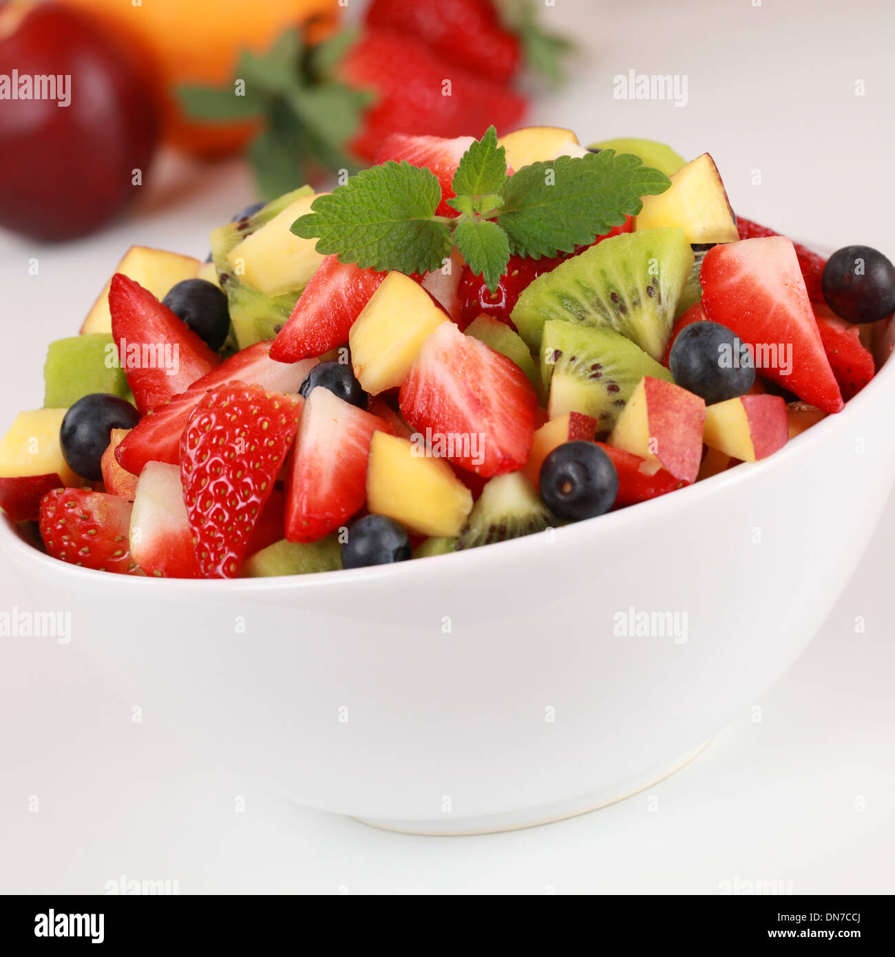 Summer fruit salad with strawberries, kiwi, blueberries and peaches Stock Photo