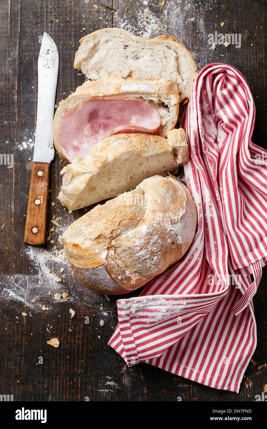 Fresh French bread with ham on wooden background Stock Photo