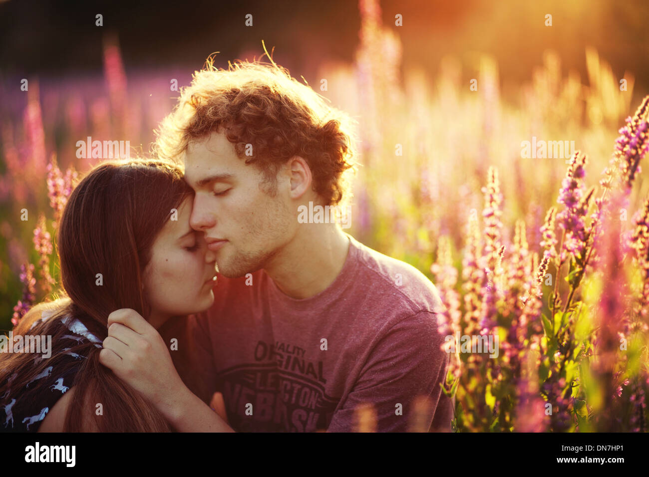 Young couple in love embracing on a meadow Stock Photo