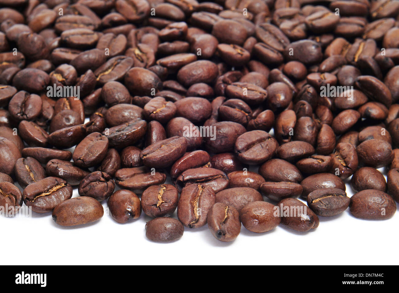 closeup of a pile of roasted coffee beans on a white background Stock ...