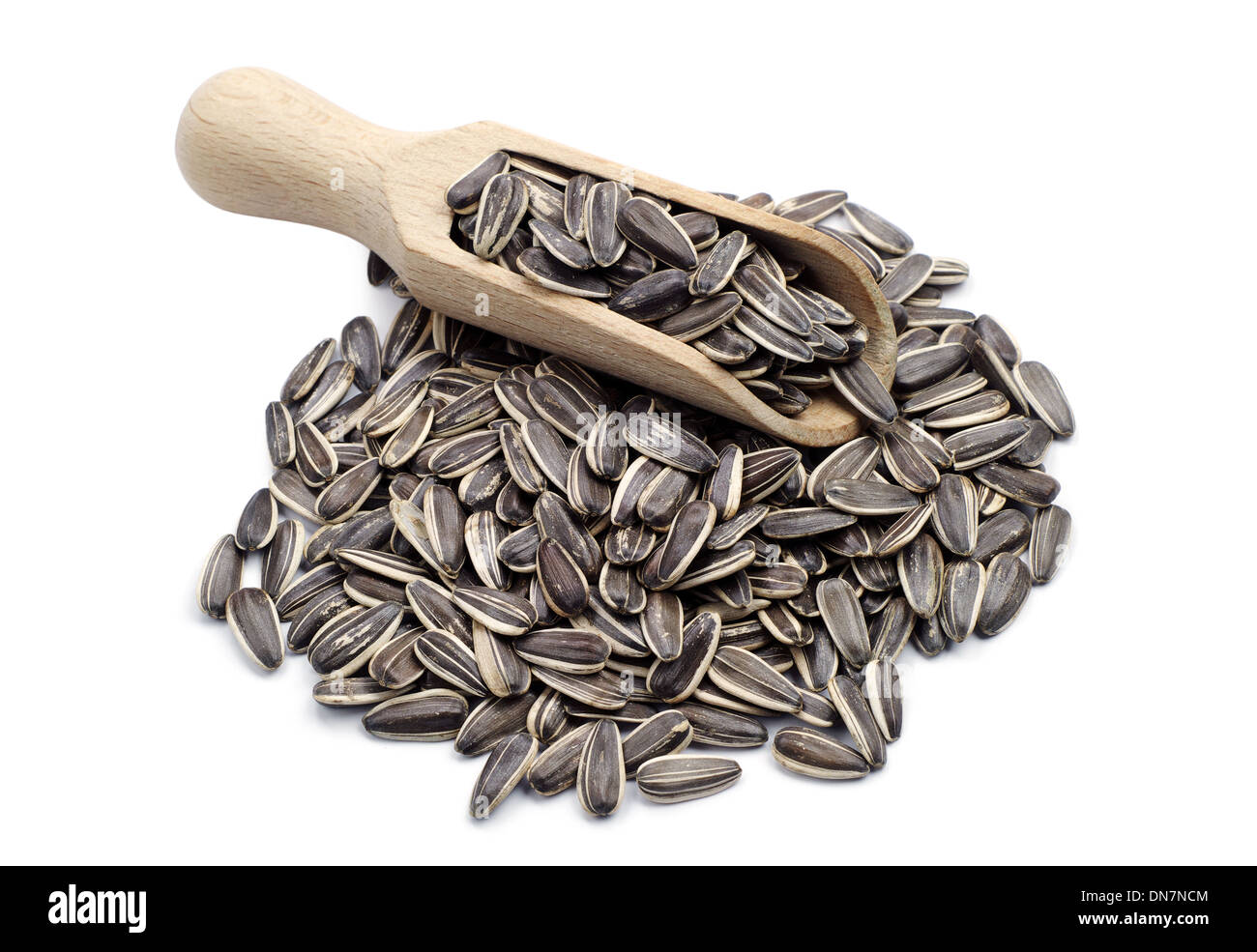 Sunflower seeds in a spoon and near on white background Stock Photo