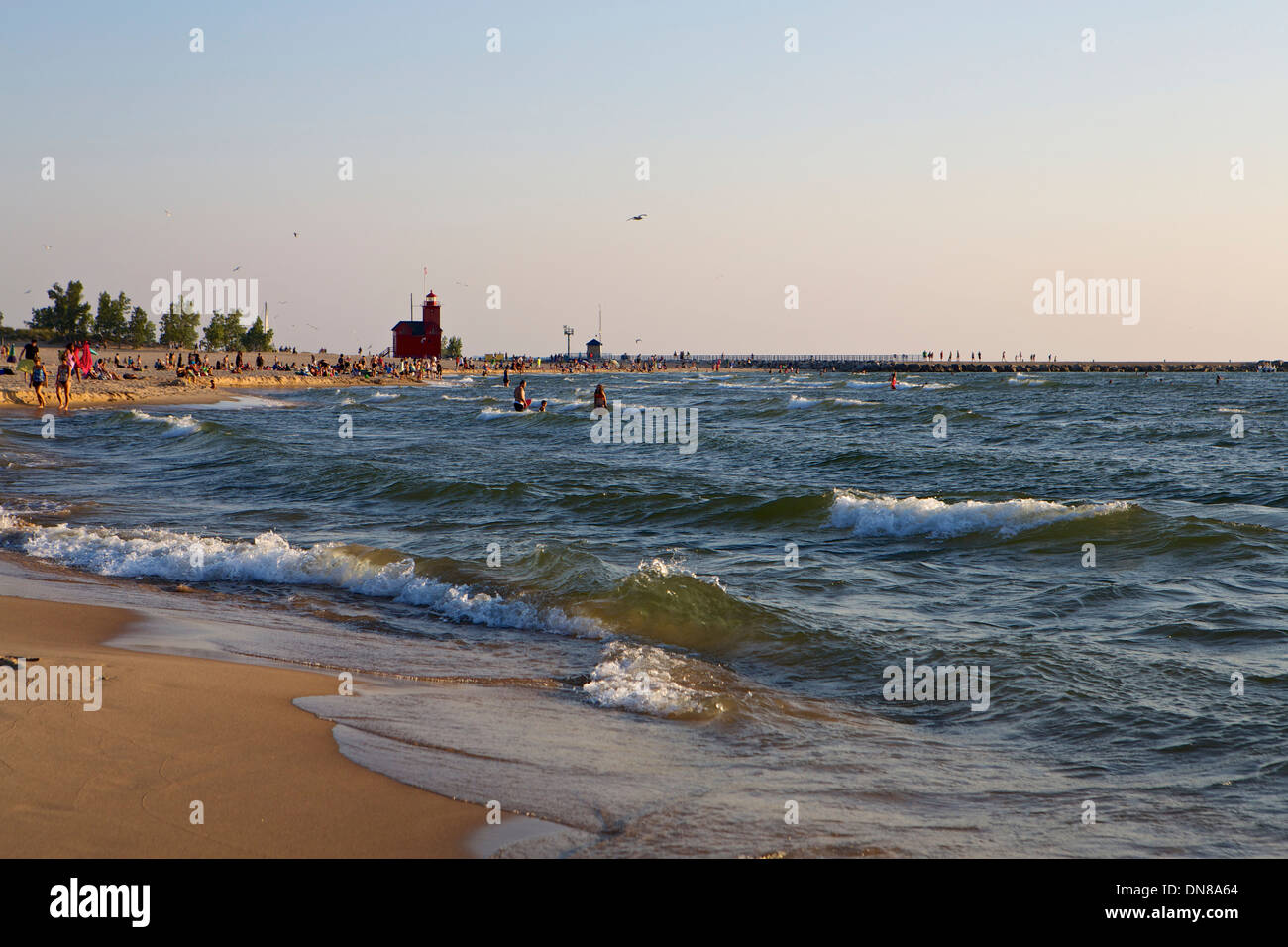 The beach at Holland State Park with the Big Red lighthouse in the distance Stock Photo