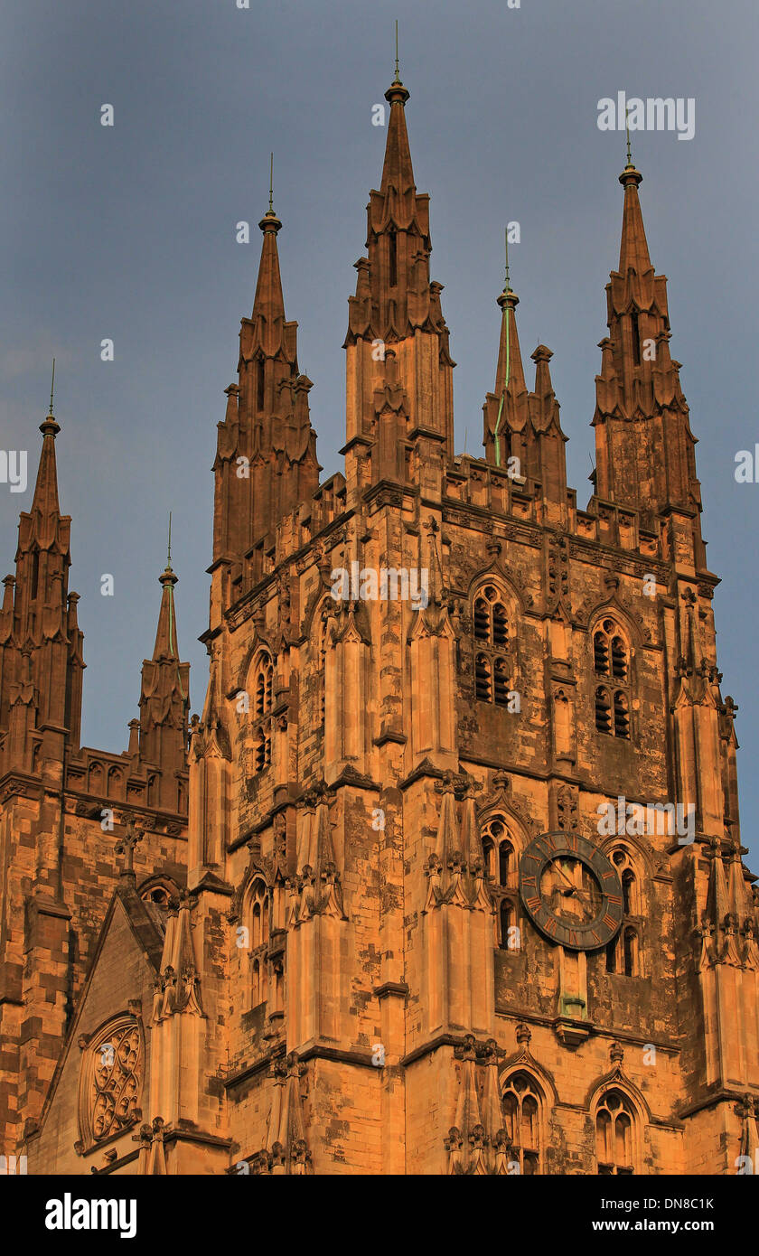 The exterior of the south west entrance tower of Canterbury Cathedral with clock at dusk Stock Photo