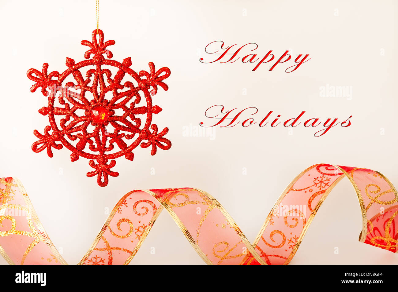 Happy Holidays card with text, ribbon and ornament Stock Photo