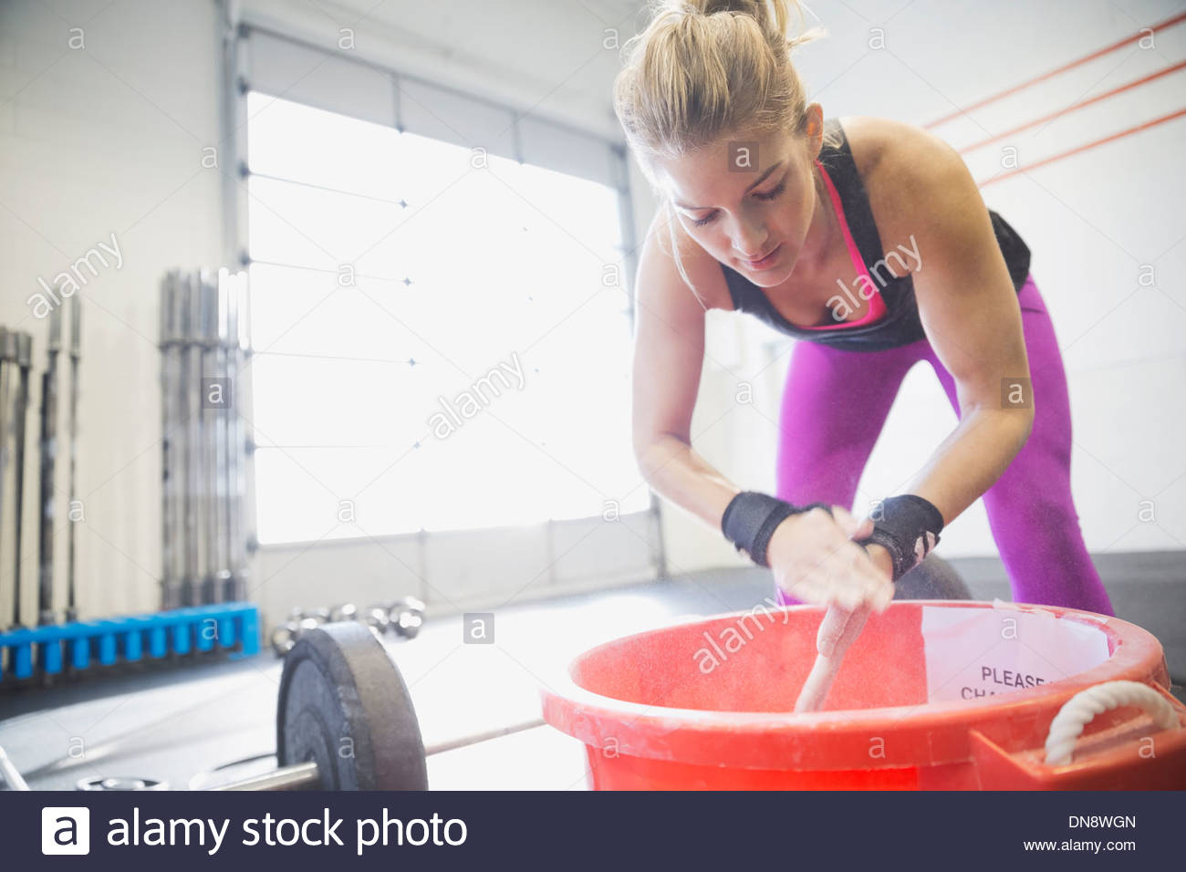 Woman chalking hands before training Stock Photo