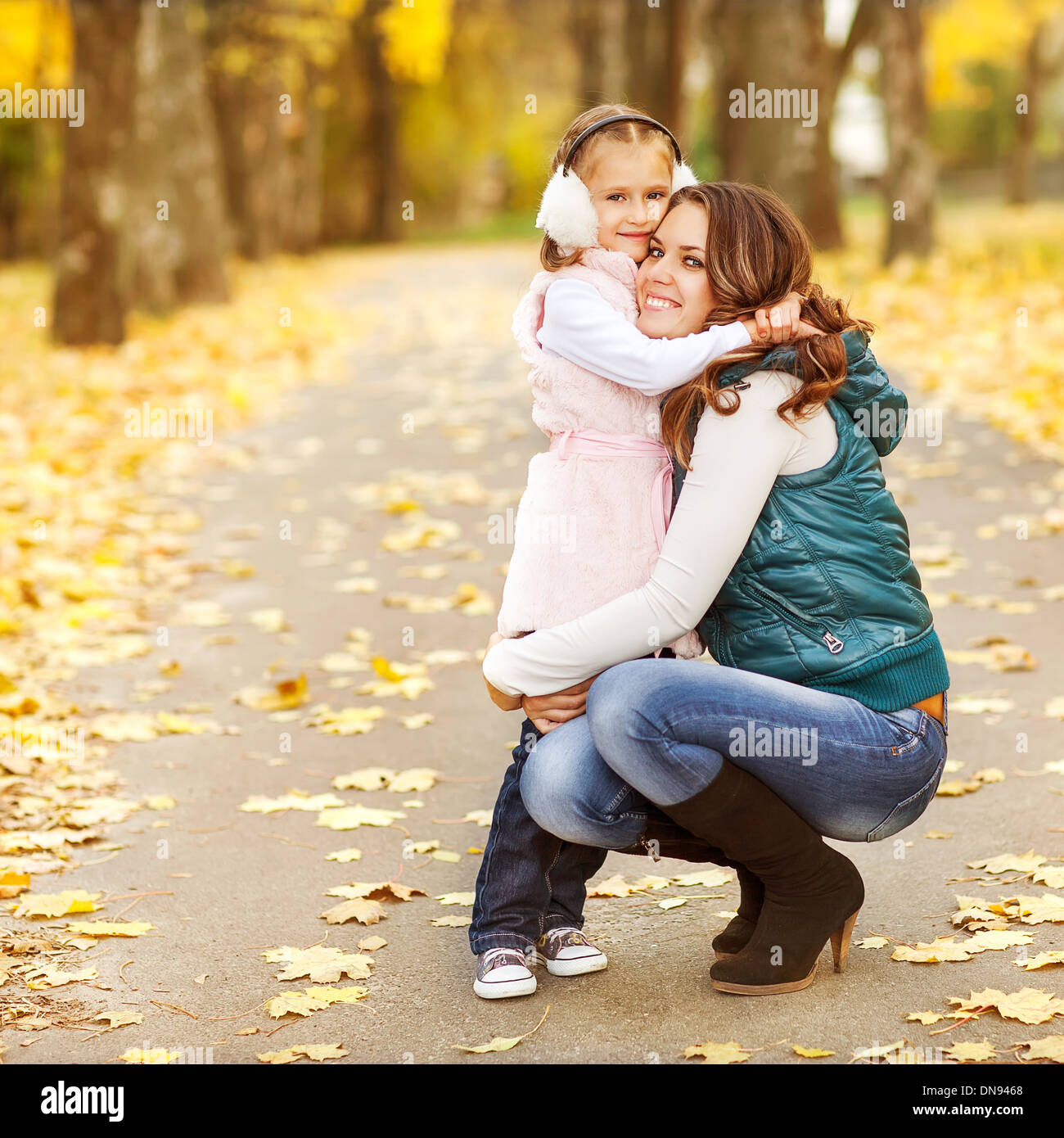 Mother and daughter having fun in the autumn park Stock Photo - Alamy