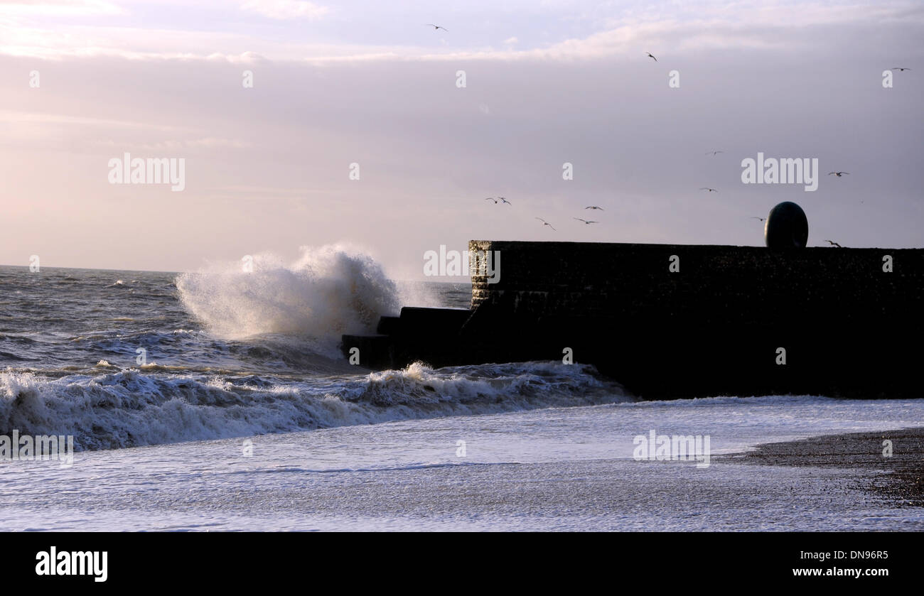 Large waves crash on to the seafront at Brighton near the pier as the sun starts to go down this afternoon with bad weather forecast for the next 24 hours Stock Photo