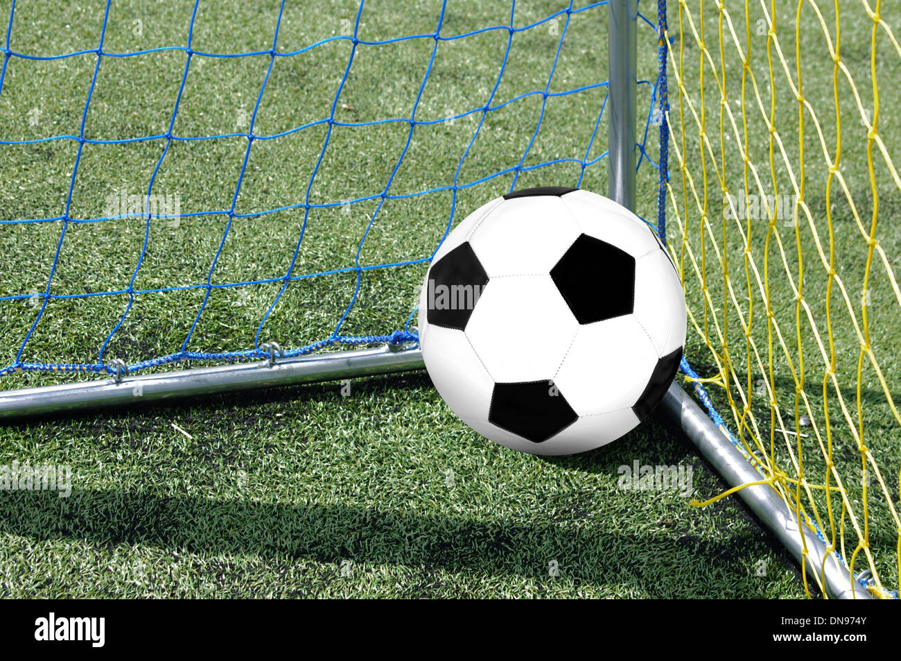 the foot ball in mesh of goal Stock Photo