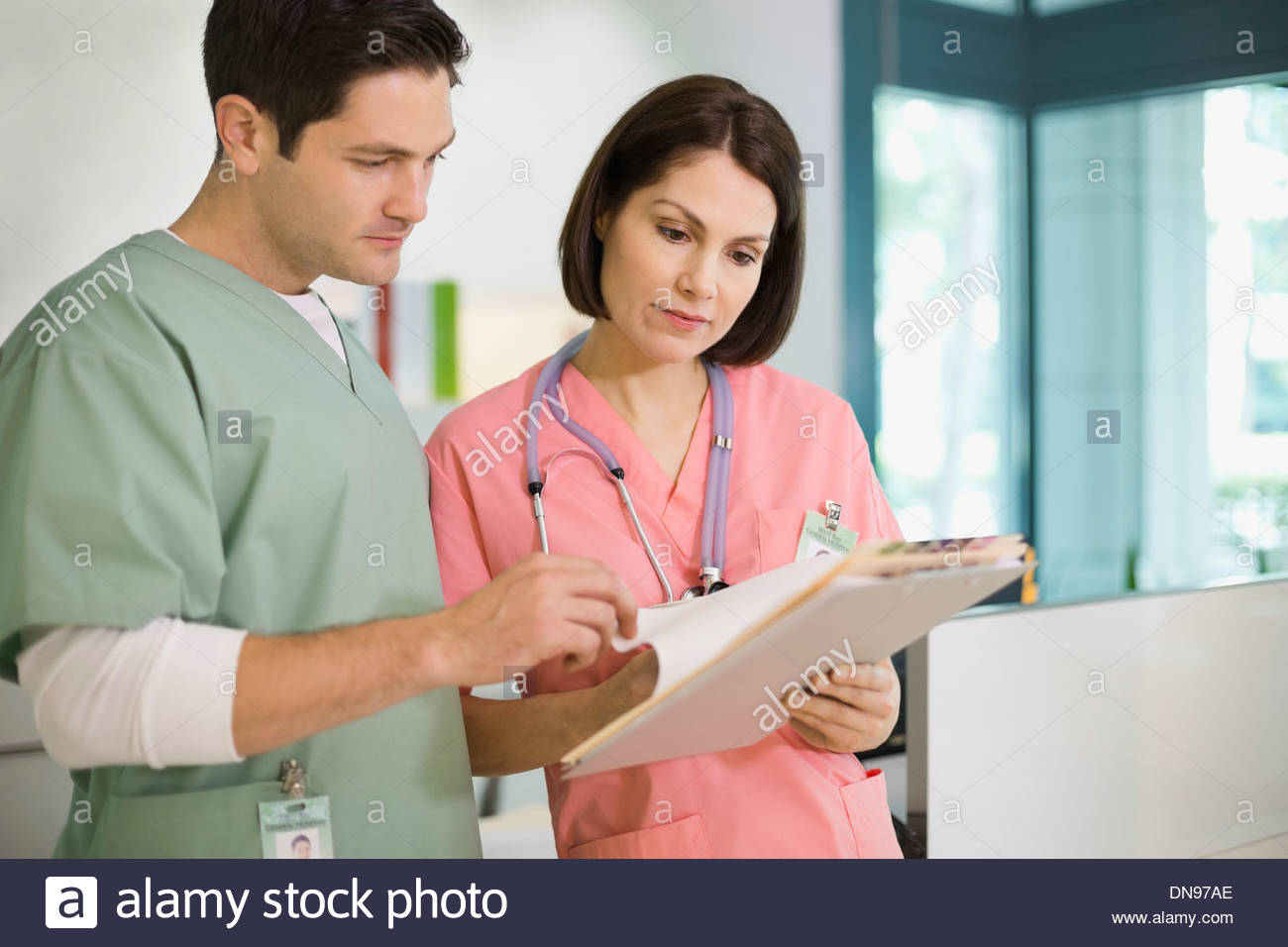 Nurses reviewing medical records Stock Photo