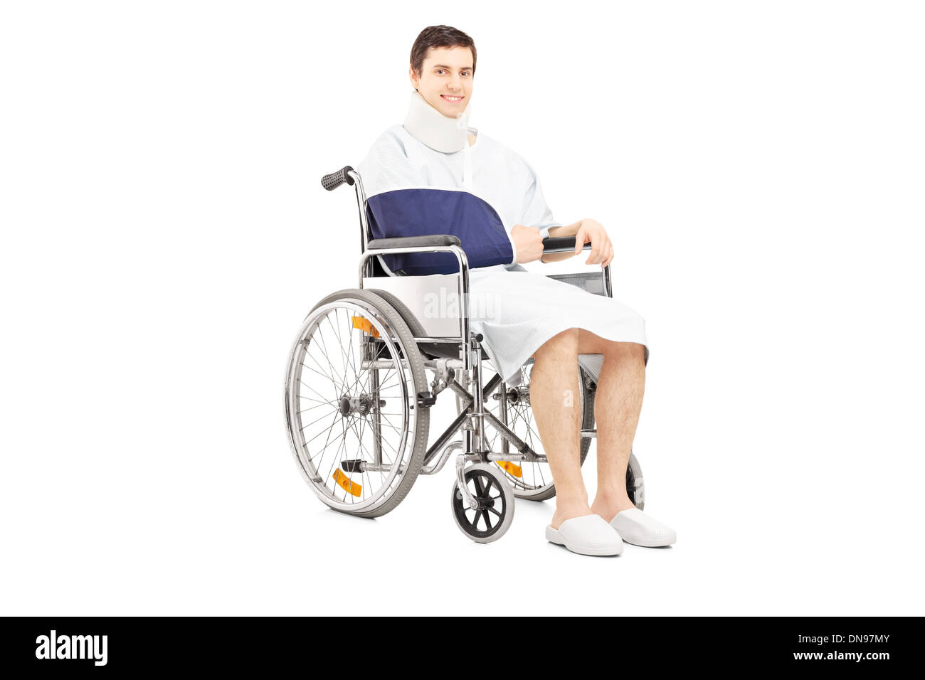 Disabled male patient with broken arm posing in a wheelchair Stock Photo