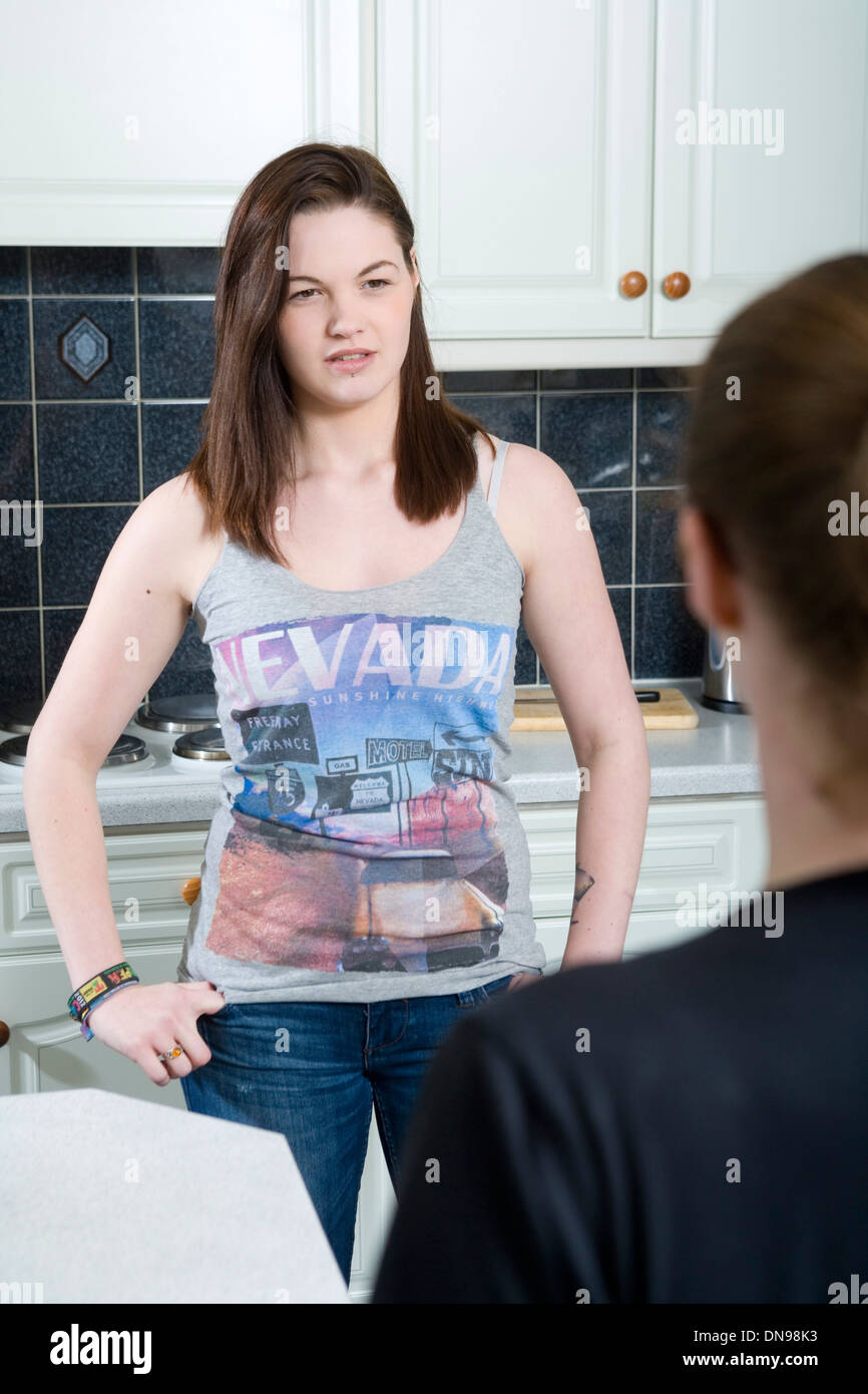 Teenage daughter and mother arguing in their Kitchen. Stock Photo