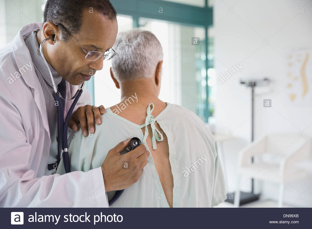 Medical doctor with a stethoscope and hands behind his back Stock Photo -  Alamy