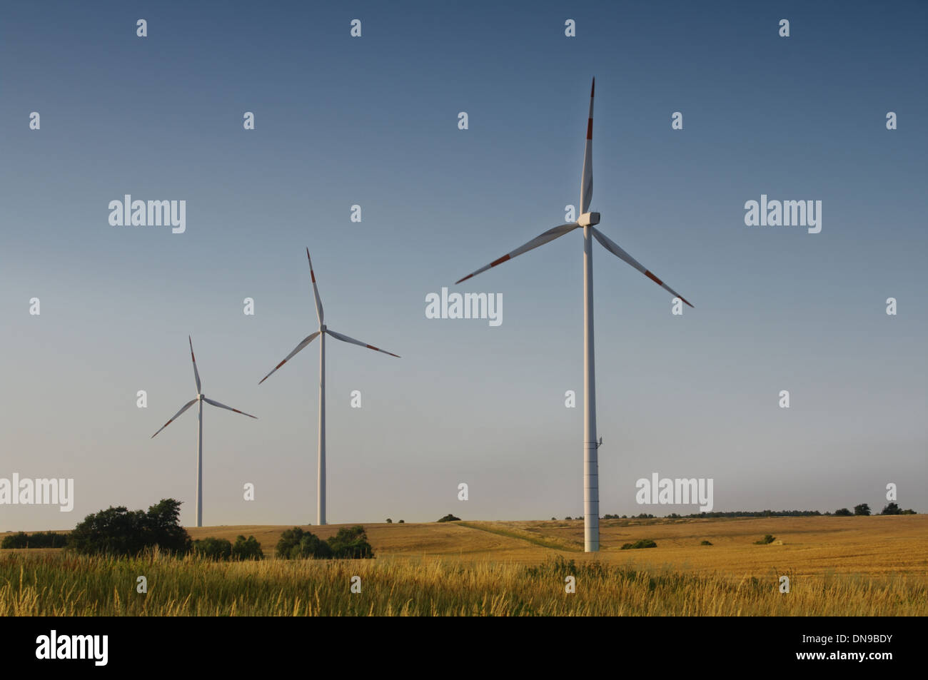 wind turbine on blue sky background Stock Photo - Alamy