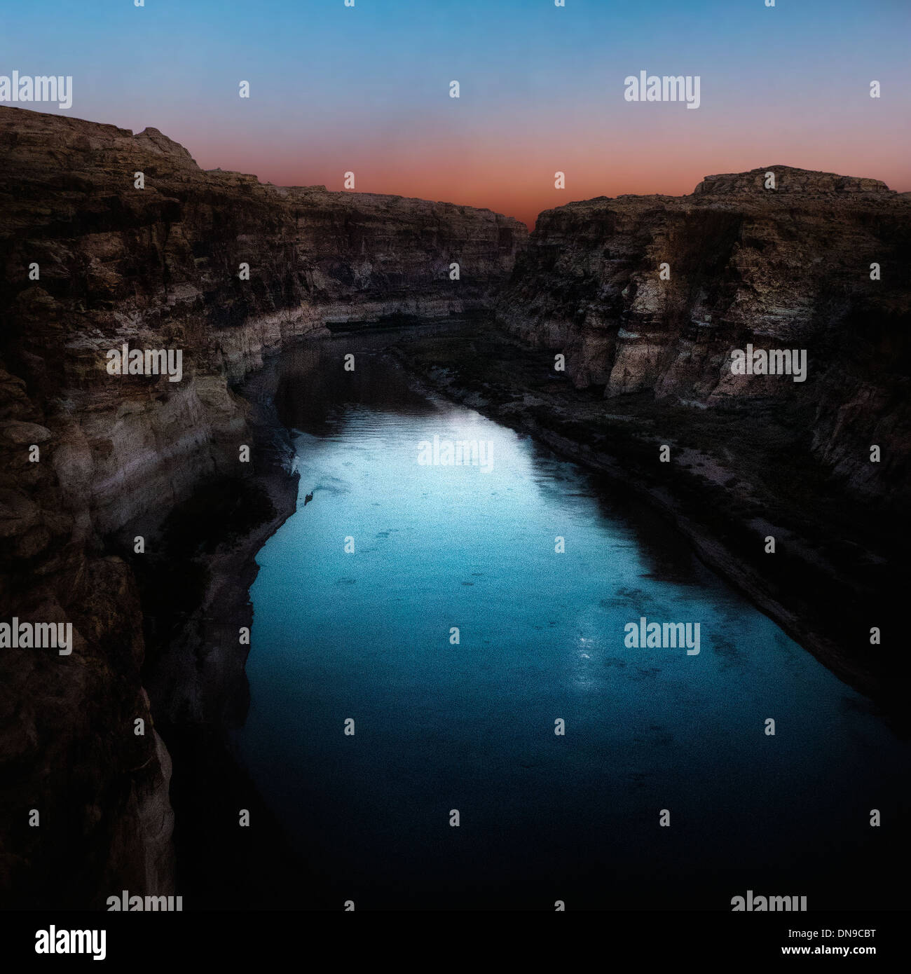 An editorial image of the Colorado River at moon rise and sun set after glow Stock Photo