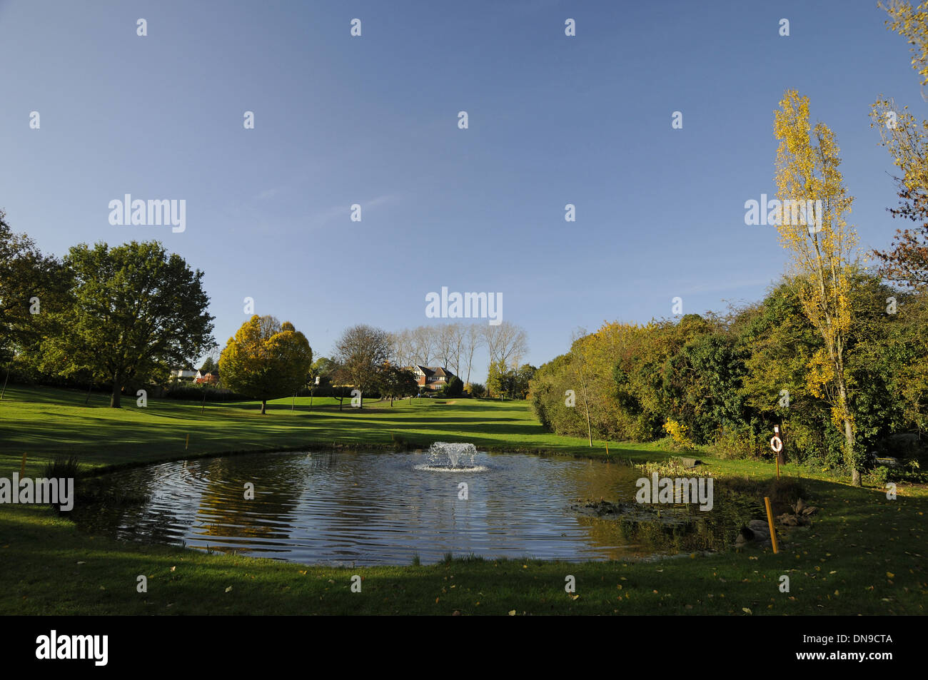 Sundridge Park Golf Club - View from Fairway over Pond with Fountain to 18th Hole and Tee with colourful Autumn Trees Bromley Stock Photo