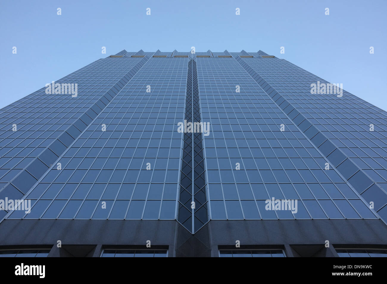A low angled shot looking up at a tall glass skyscraper in Downtown London Ontario - Canada. Stock Photo