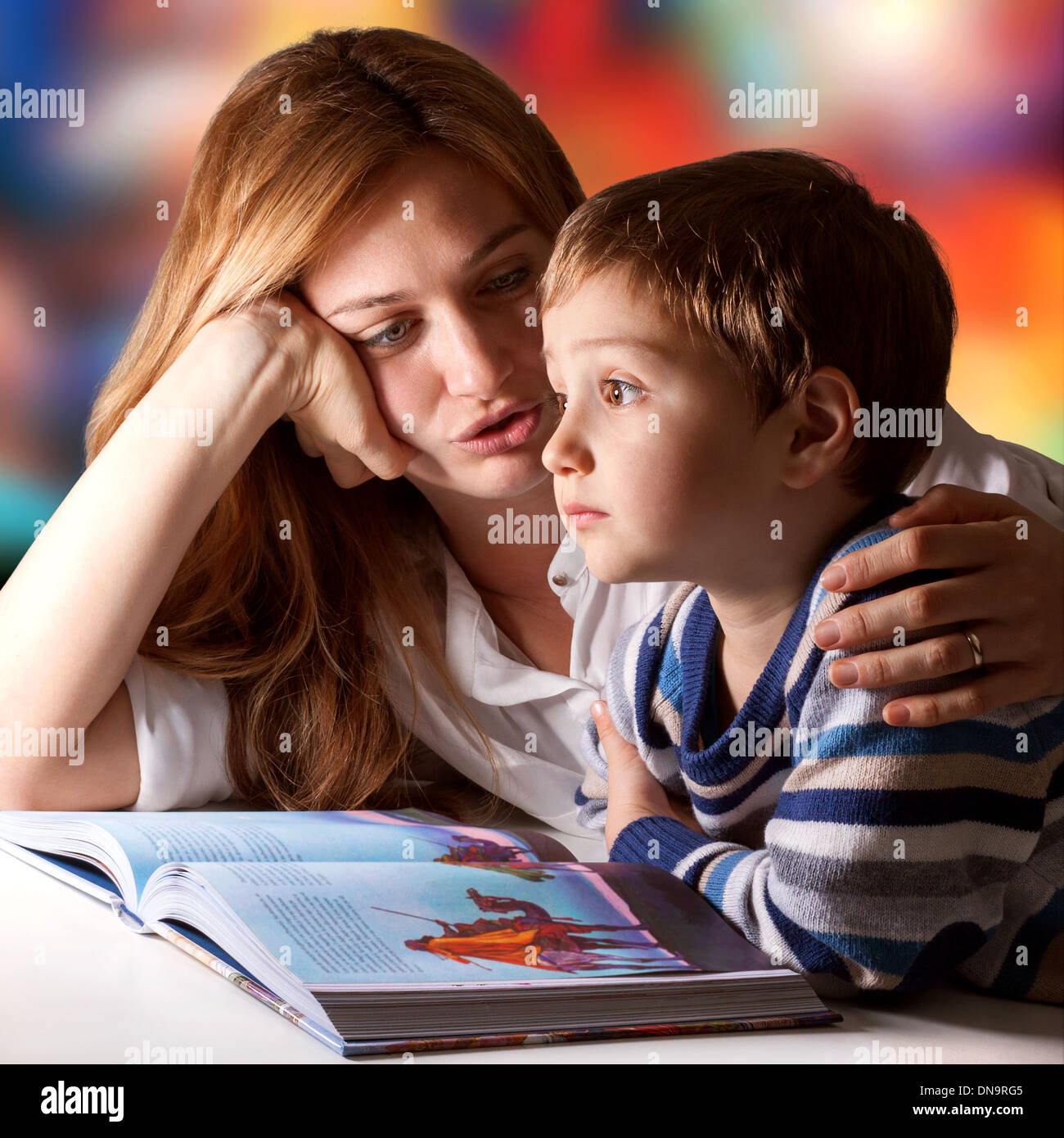 Little boy listening to his mother telling him stories Stock Photo