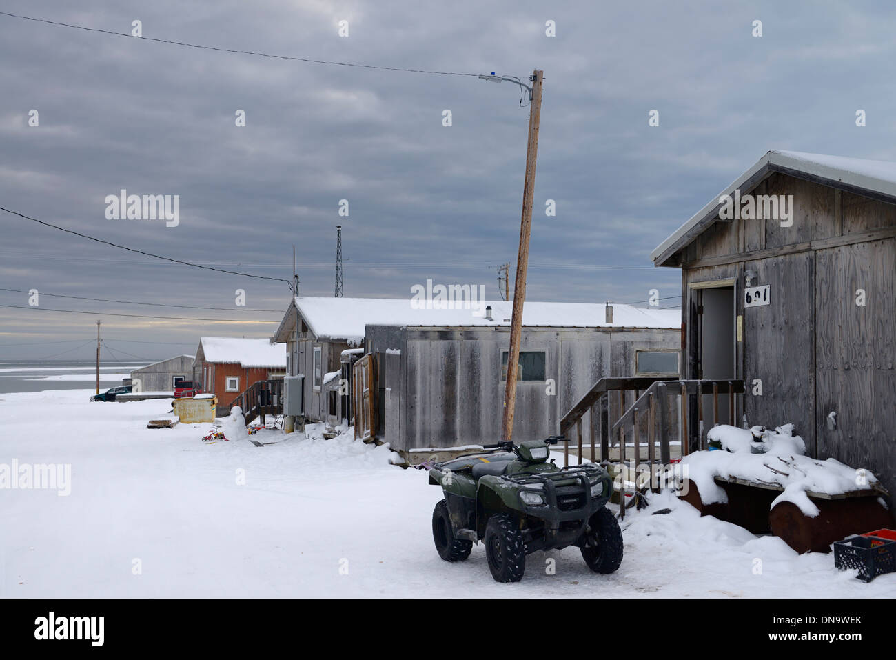 ATV and snowman in Eskimo village street of Kaktovik Alaska USA on the Beaufort Sea Arctic Ocean Stock Photo
