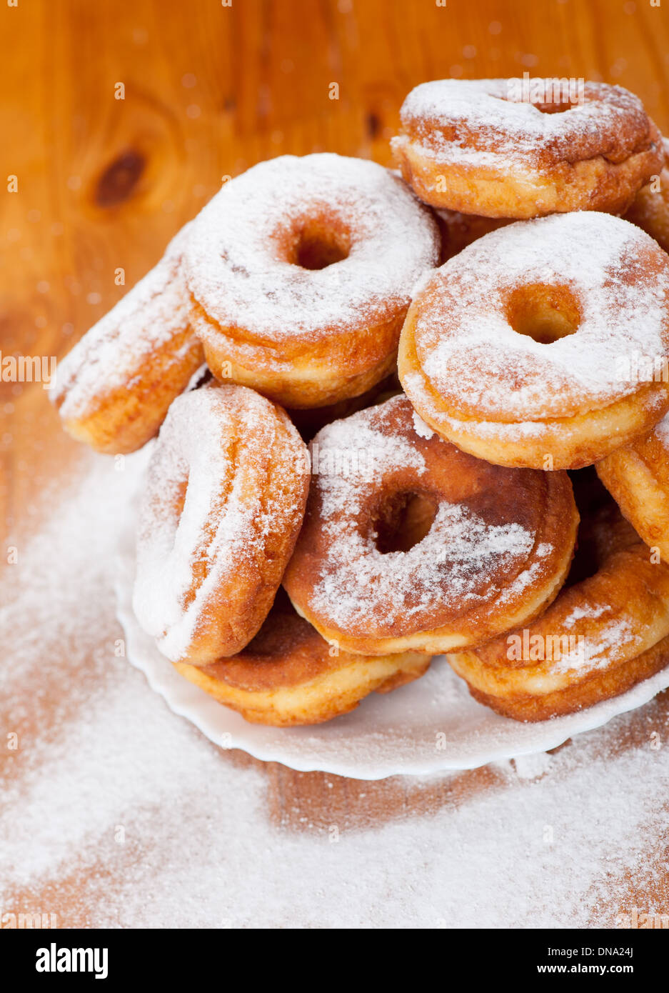 stack of sweet and caloric donuts with holes and powdered sugar Stock Photo