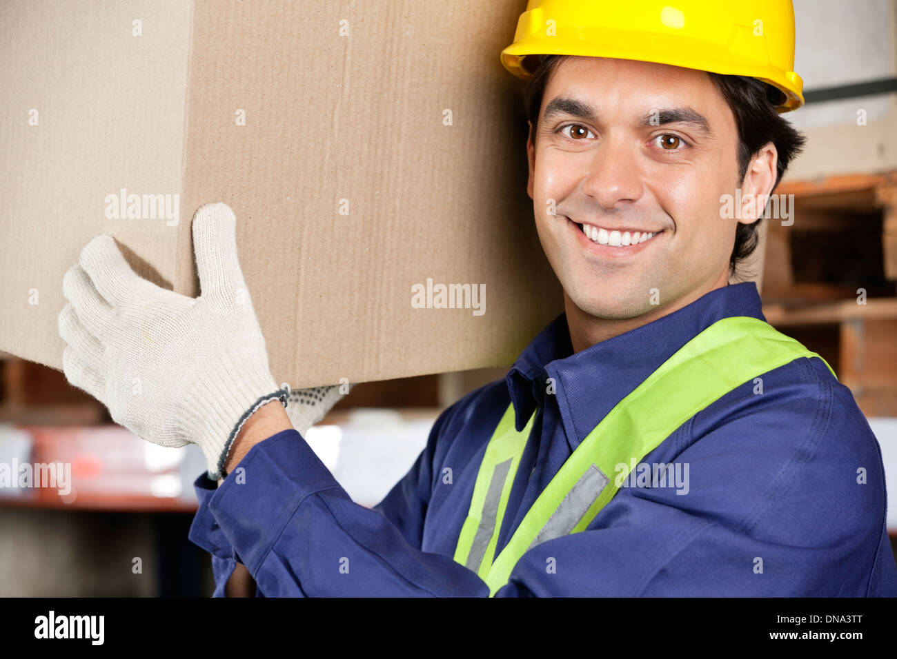 Young Foreman Lifting Cardboard Box Stock Photo Alamy