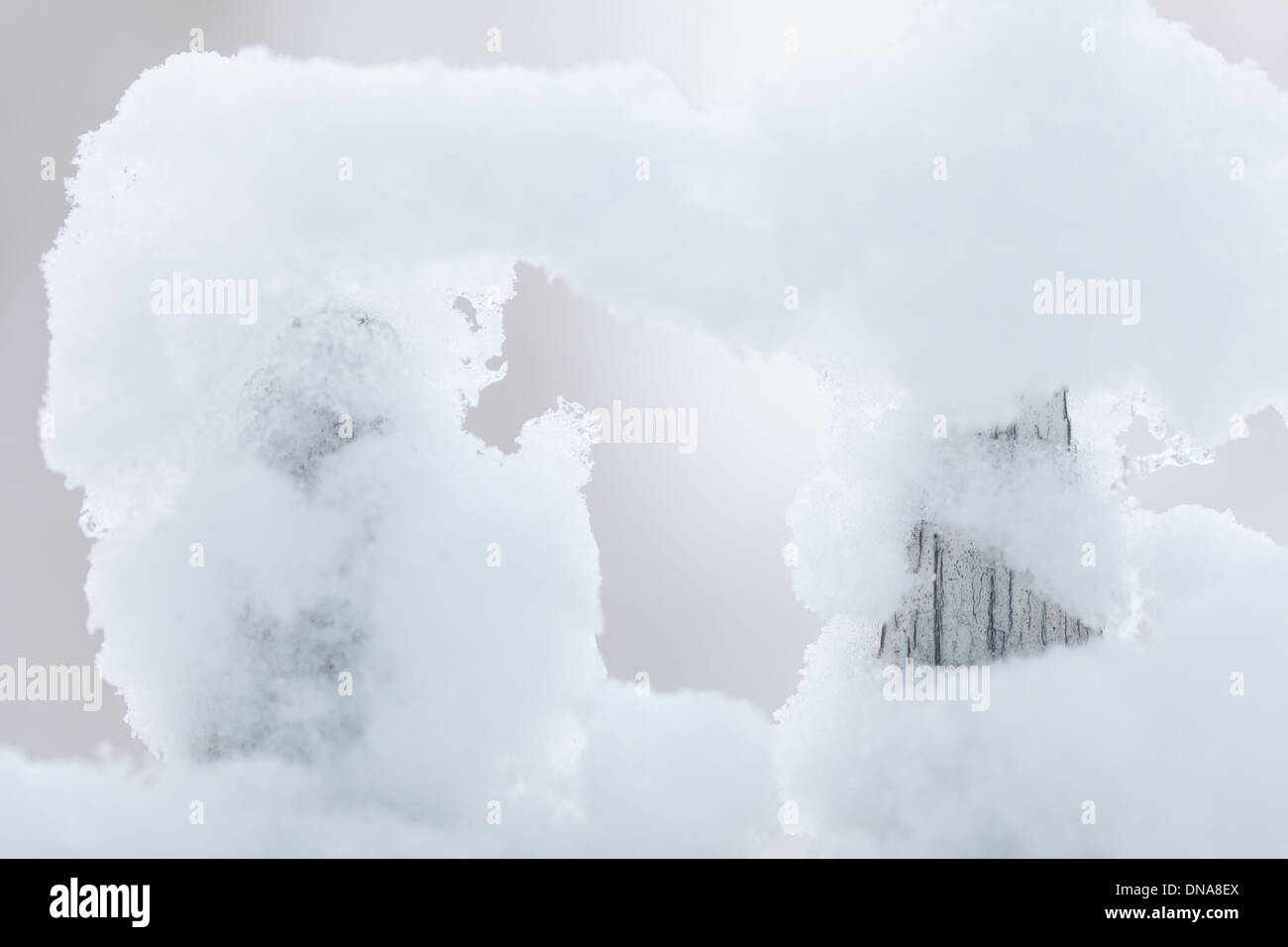 Old white wooden wood fence covered with fresh snow on winter season ...