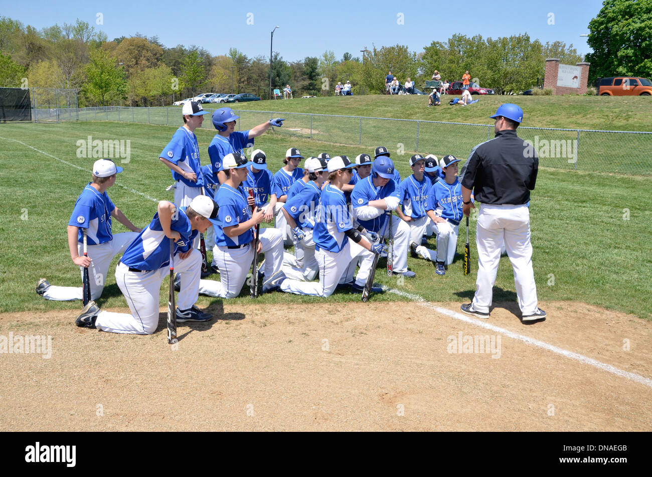 Baseball coach talks to his high school baseball team Stock Photo