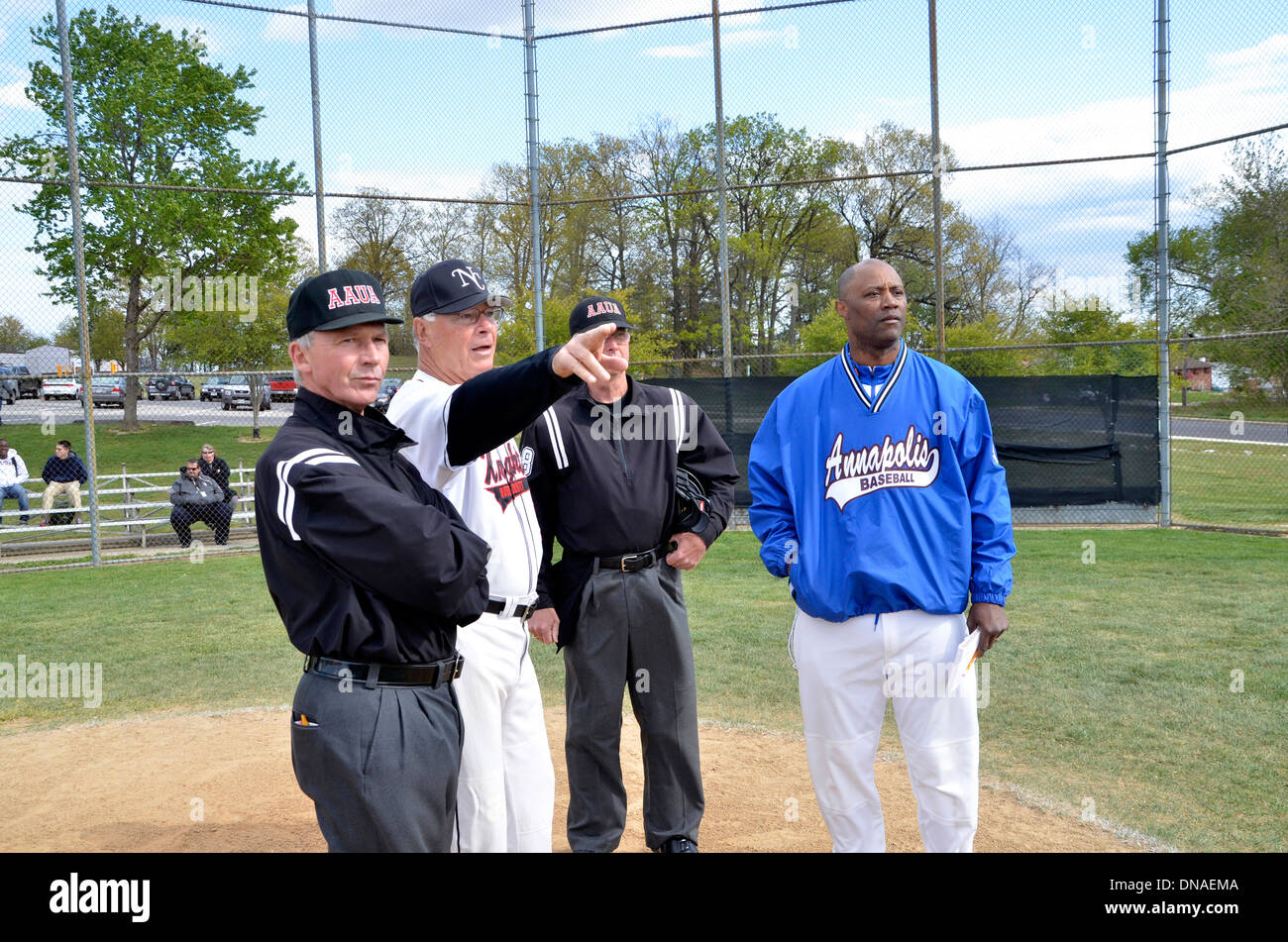 coach explain the field layout to the umpires in a baseball game Stock