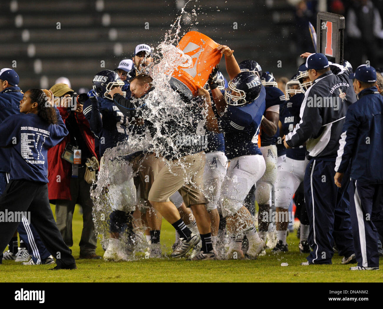 Carson, California, USA. 20th Dec, 2013. December 20, 2013 Carson, CA. Bakersfield Drillers offensive linesman Joshua Nunez #60 dumps a gatorade jug of water on Bakersfield Drillers head coach Paul Golla after defeating the Del Oro Golden Eagles in the CIF State Division 4 Championship Bowl game between the Del Oro Golden Eagles and the Bakersfield Drillers at the Stub Hub Center in Carson, CA. David Hood/CSM. Credit:  csm/Alamy Live News Stock Photo