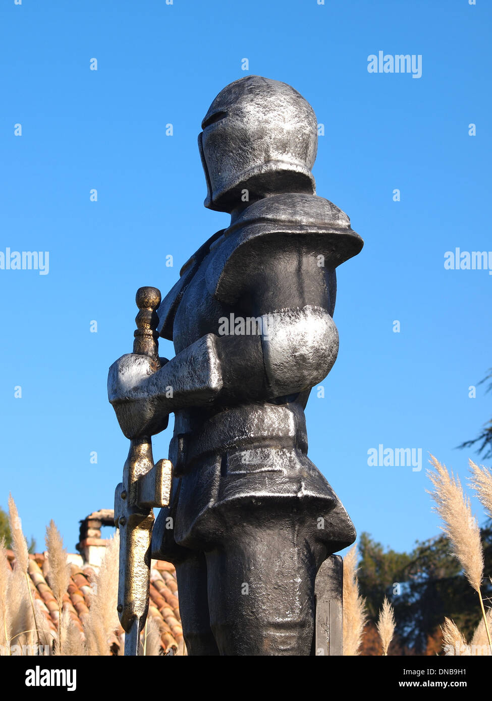 statue of Knight Swordsman in Full Armour standing in front of museum Stock Photo
