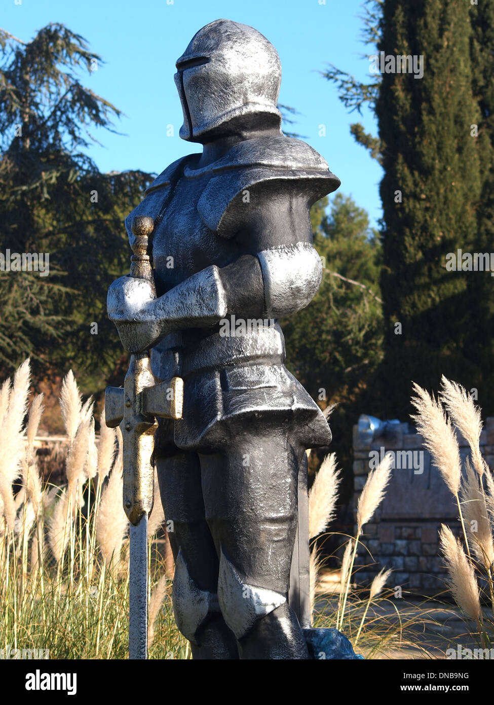 statue of Knight Swordsman in Full Armour standing in front of museum  Stock Photo