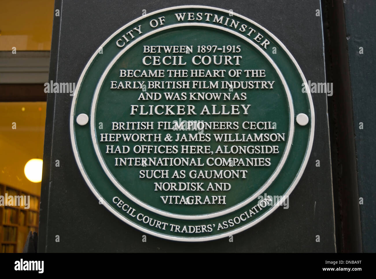westminster council green plaque marking flicker alley, a nickname of cecil court when home to the early british film industry Stock Photo
