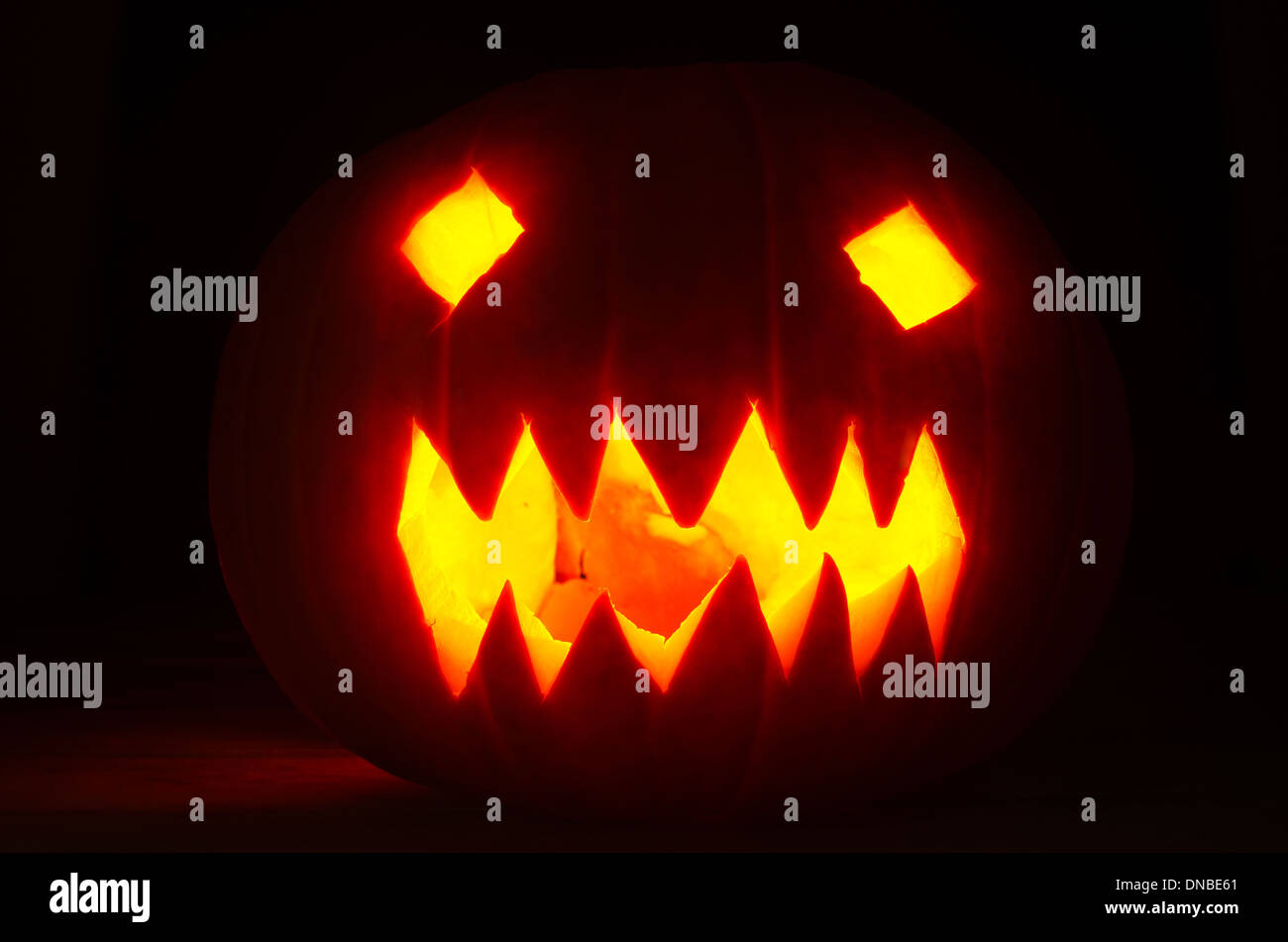 Jack O Lantern Halloweens Pumpkin On Dark Dried Leaves Glowing Eyes Stock Photo Alamy