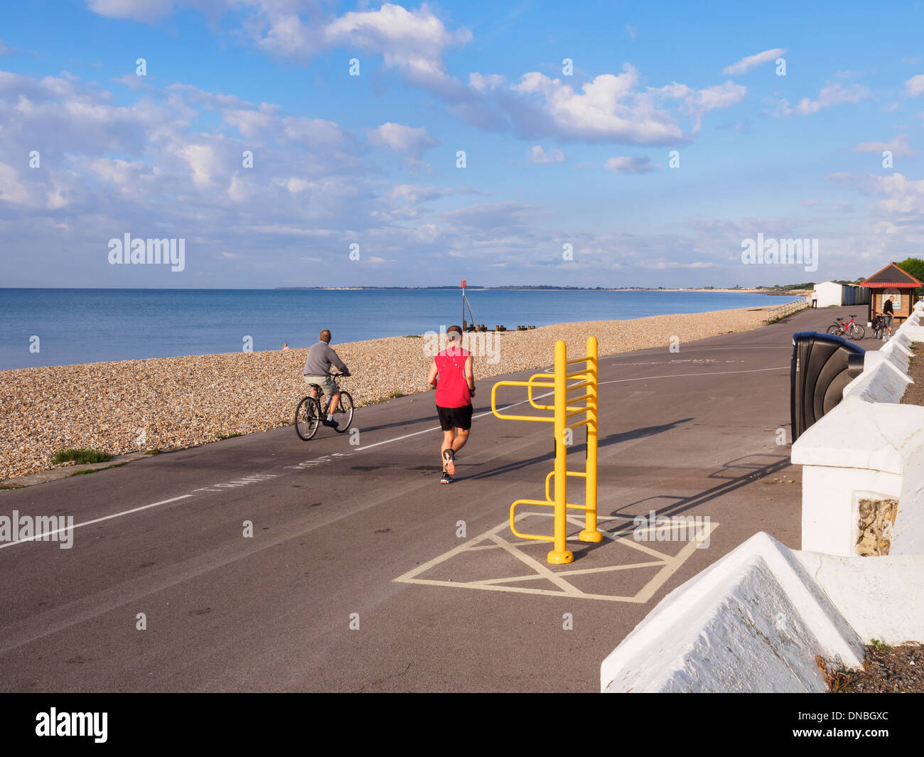 Man jogging by the sea along the quiet seafront promenade in Aldwick, Bognor Regis, West Sussex, England, UK, Britain Stock Photo