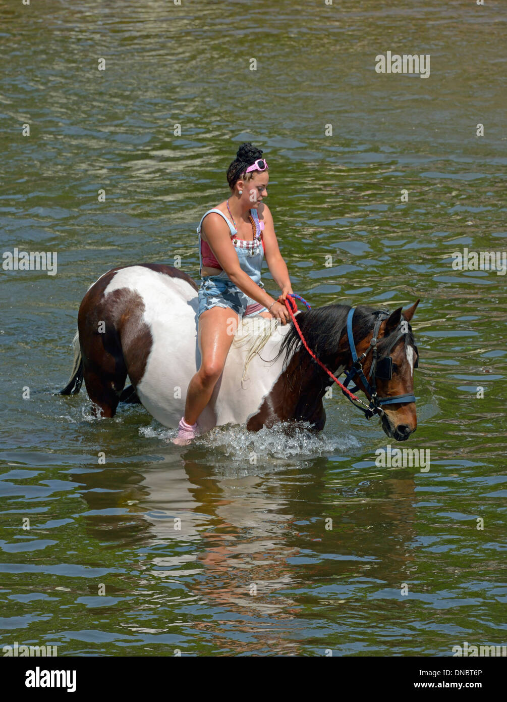 Gypsy traveller girl riding horse in River Eden. Appleby Horse Fair, Appleby-in-Westmorland, Cumbria, England, United Kingdom. Stock Photo