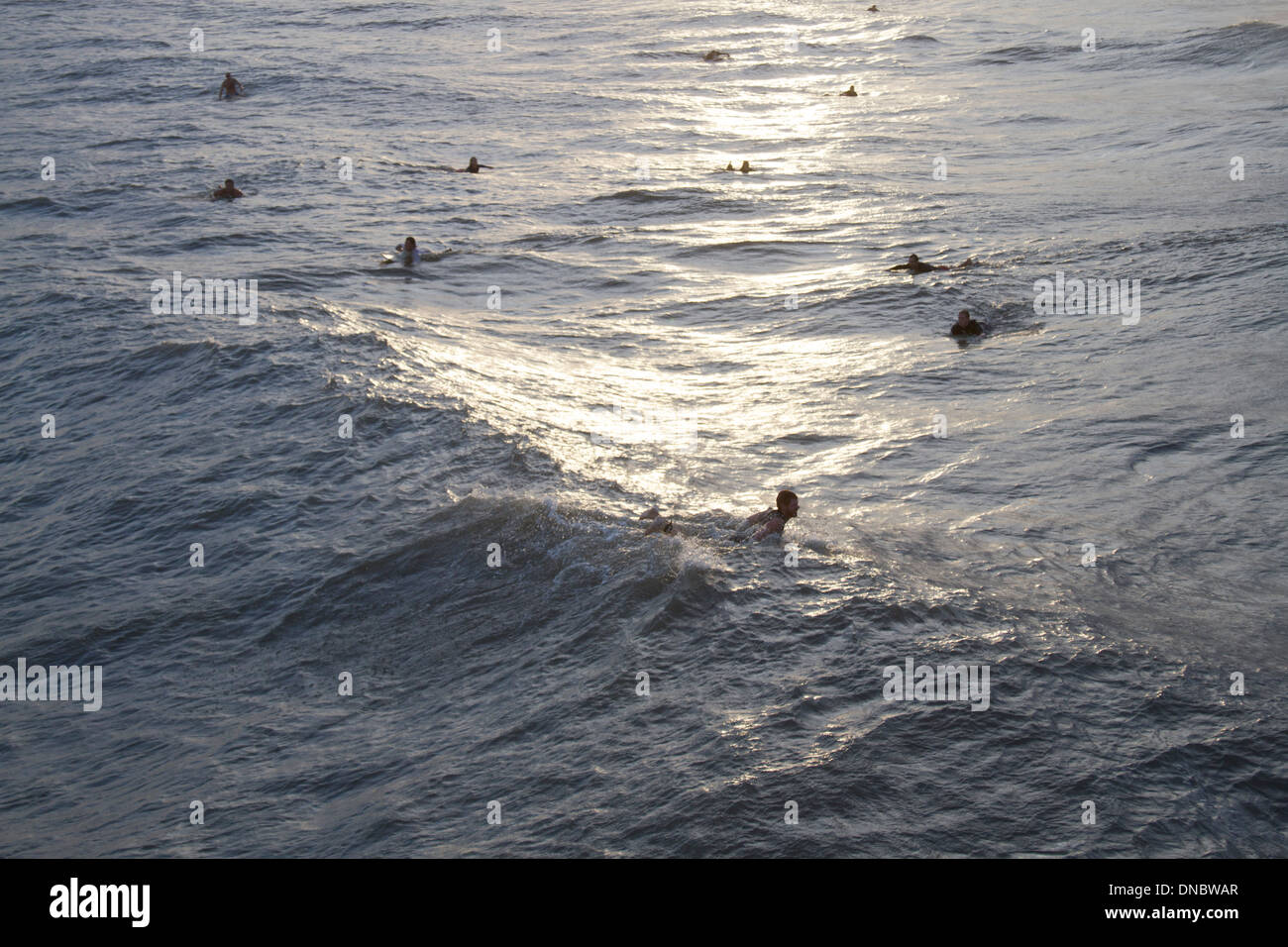 Folly Beach, South Carolina, USA - October, 25, 2012: Surfers wait for Hurricane Sandy Waves at sunset Stock Photo