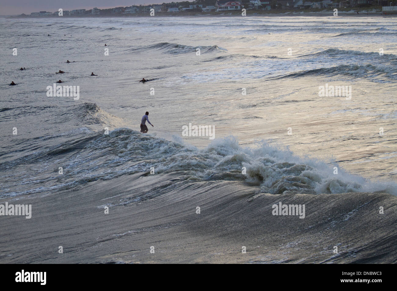 Folly Beach, South Carolina, USA - October, 25, 2012: Surfers surfing Hurricane Sandy Waves Stock Photo