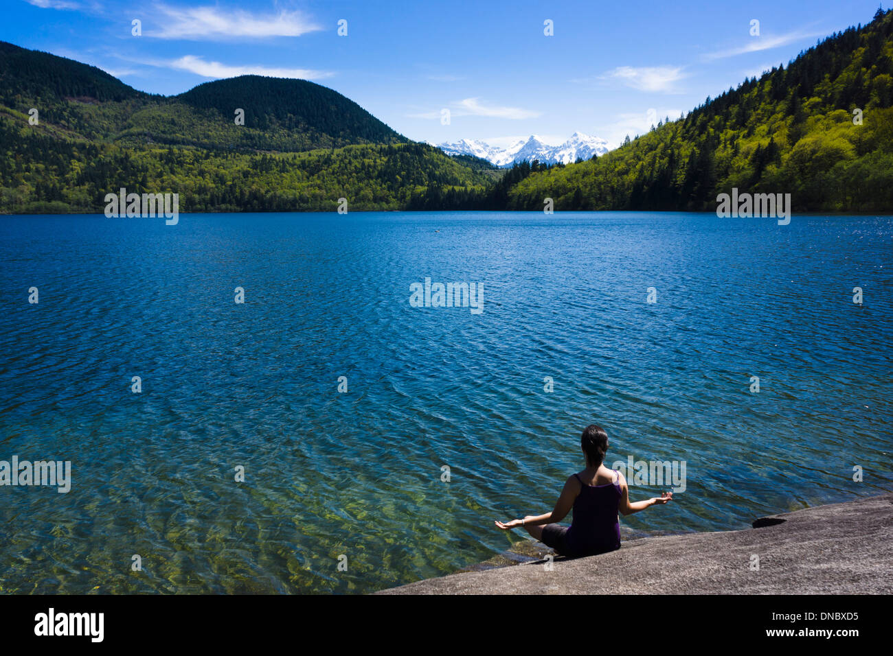 Young woman meditating at Hicks Lake in Sasquatch Provincial Park, British Columbia, Canada Stock Photo