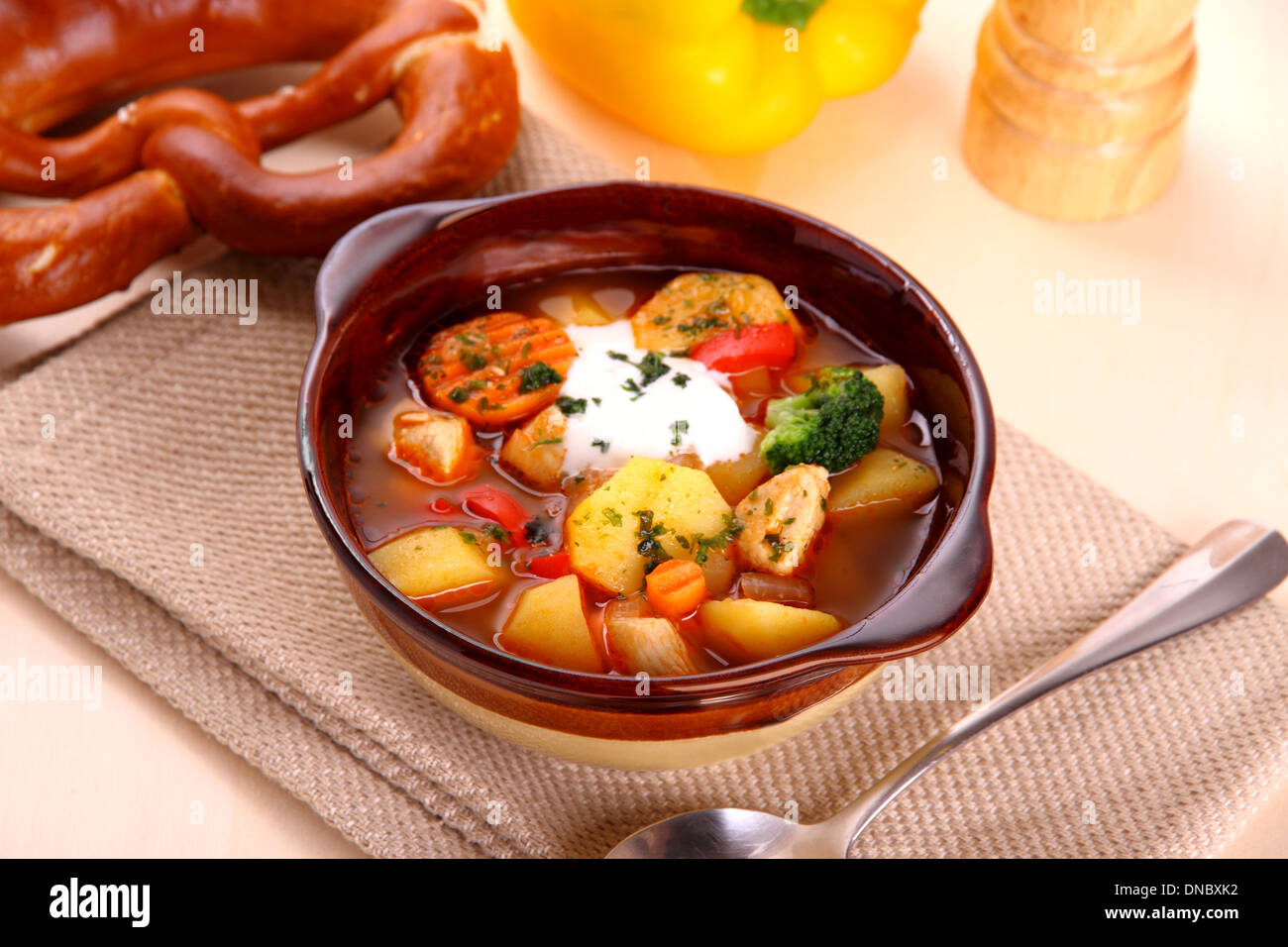 Vegetable stew with chicken and potato, pretzel, close up Stock Photo