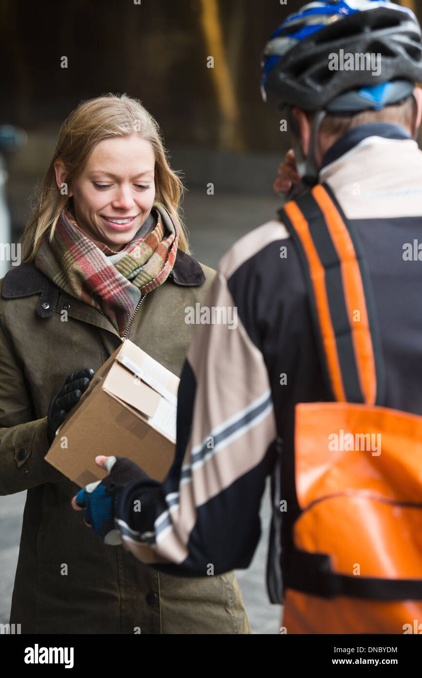 Young Woman Receiving A Package Stock Photo