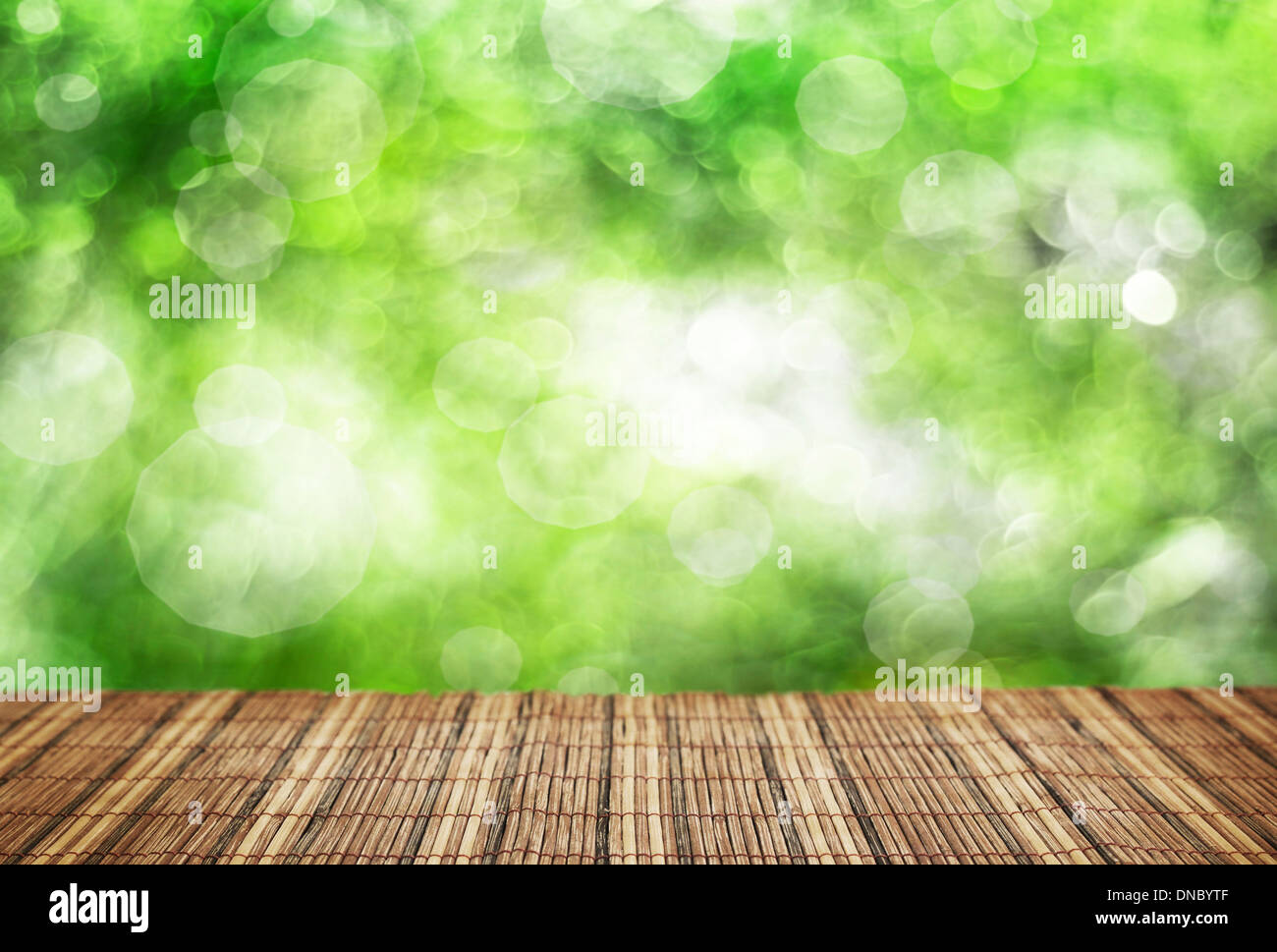 Empty bamboo table and defocused green foliage background Stock Photo ...