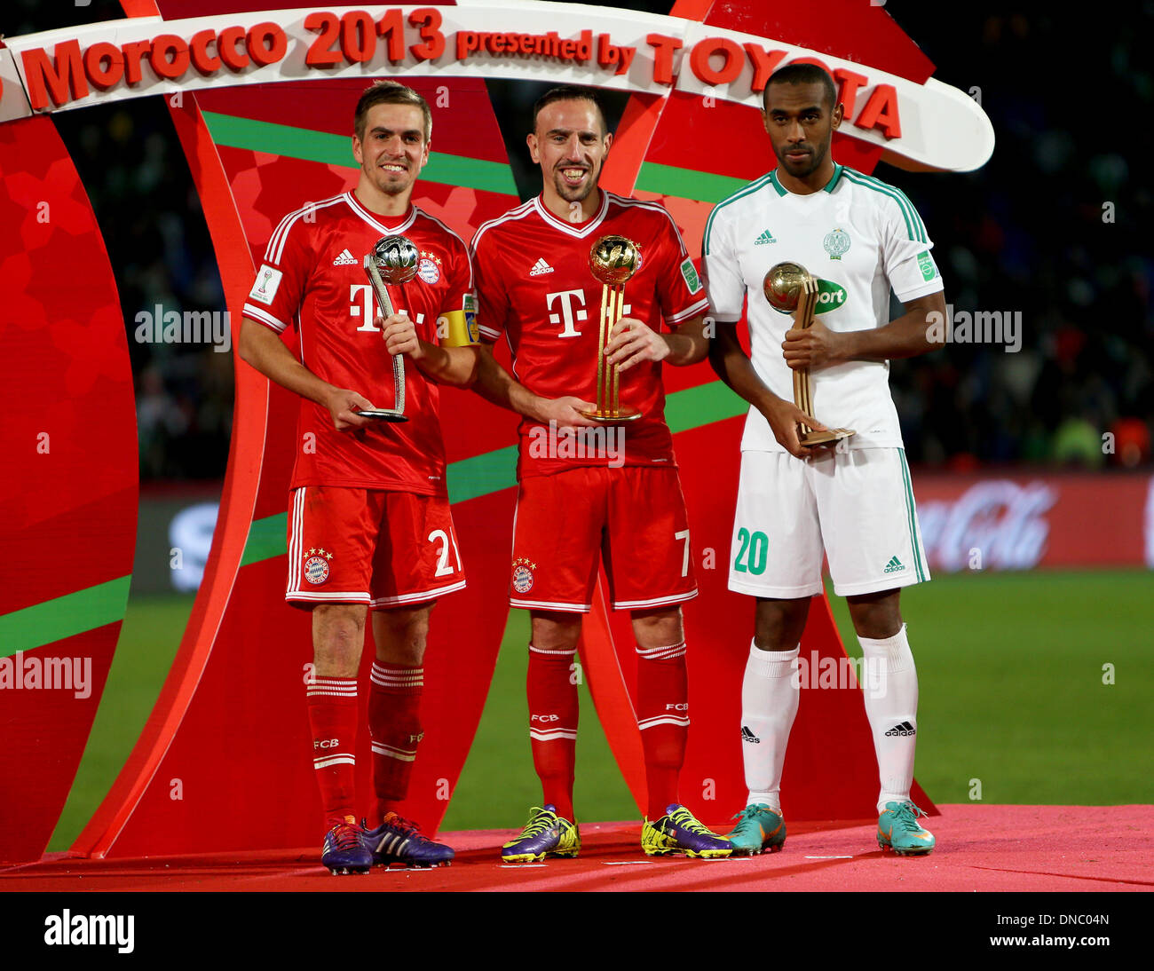 Marrakech , Morocco. 21st Dec, 2013. Phillip LAHM (L) Frank RIBERY (M) Mouhssine IAJOUR (R) celebrate winning their trophies after the FIFA Club World Cup Final game between Bayern Munich and Raja Casablanca from the Marrakech Stadium. Credit:  Action Plus Sports/Alamy Live News Stock Photo