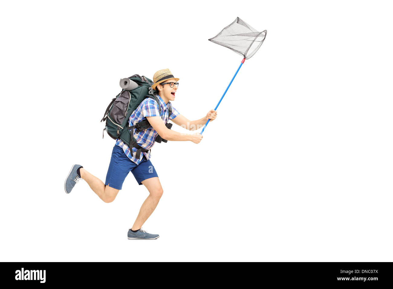 Full length portrait of a male tourist running with butterfly net Stock Photo