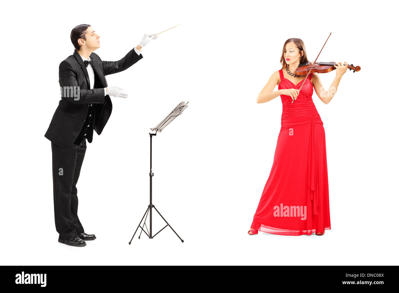 Male orchestra conductor directing a female playing violin Stock Photo