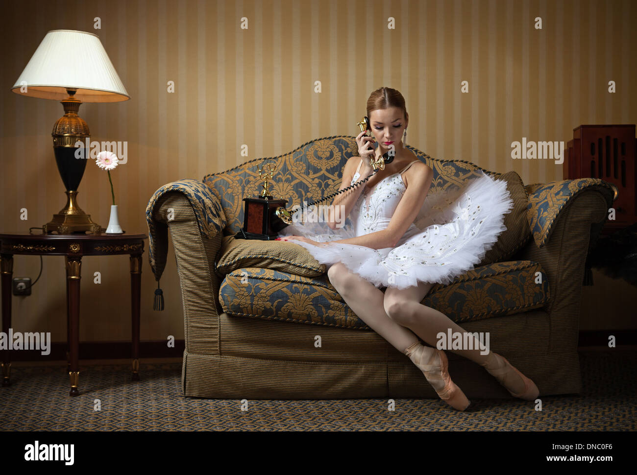 Professional ballet dancer talking on the phone in luxury interior Stock Photo