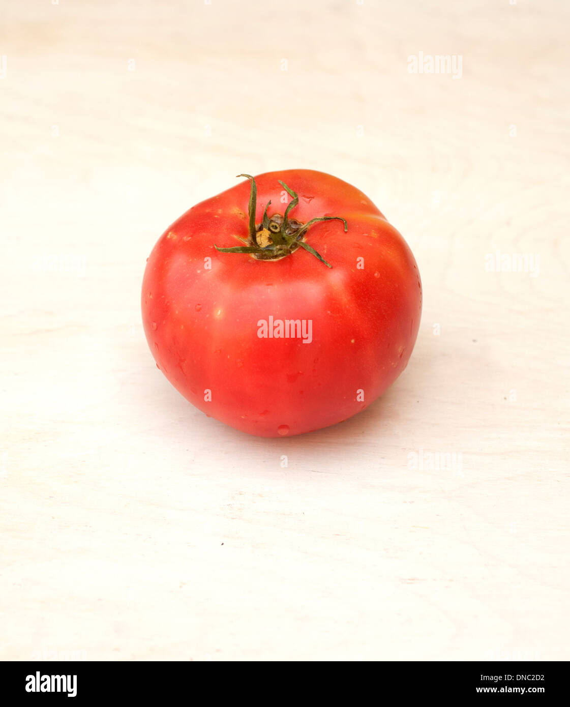 Whole red tomato on white background Stock Photo