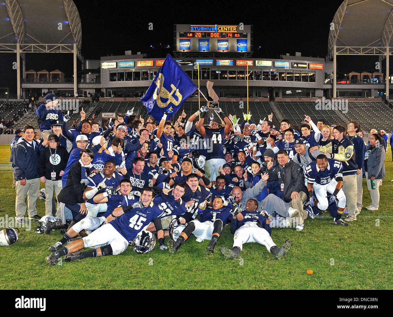 Carson, CA, . 21st Dec, 2013. Saint John Bosco Braves head coach Jason Negron and his players pose for a photo after winning the CIF Open Division California State Football Championship football game between the Concord De La Salle Spartans and the Saint John Bosco Braves at the StubHub Center in Carson, California.The Saint John Bosco Braves defeat the Concord De La Salle Spartans 20-14.Louis Lopez/CSM/Alamy Live News Stock Photo