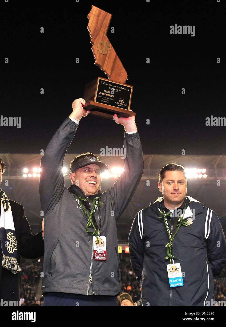Carson, CA, . 21st Dec, 2013. Saint John Bosco Braves head coach Jason Negron hoists the Championship trophy after winning the CIF Open Division California State Football Championship football game between the Concord De La Salle Spartans and the Saint John Bosco Braves at the StubHub Center in Carson, California.The Saint John Bosco Braves defeat the Concord De La Salle Spartans 20-14.Louis Lopez/CSM/Alamy Live News Stock Photo