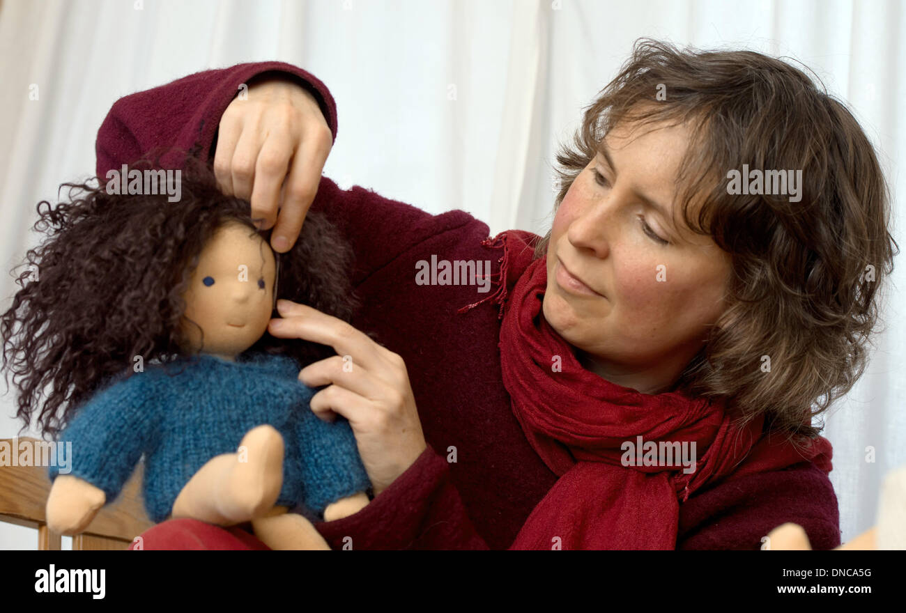 Niebendorf, Germany. 14th March, 2013. The doll maker Julia  Dobrusskin-Schautt shows one of her dolls in Niebendorf, Germany, 14 March  2013. The dolls are made of natural materials like cotton fabric and