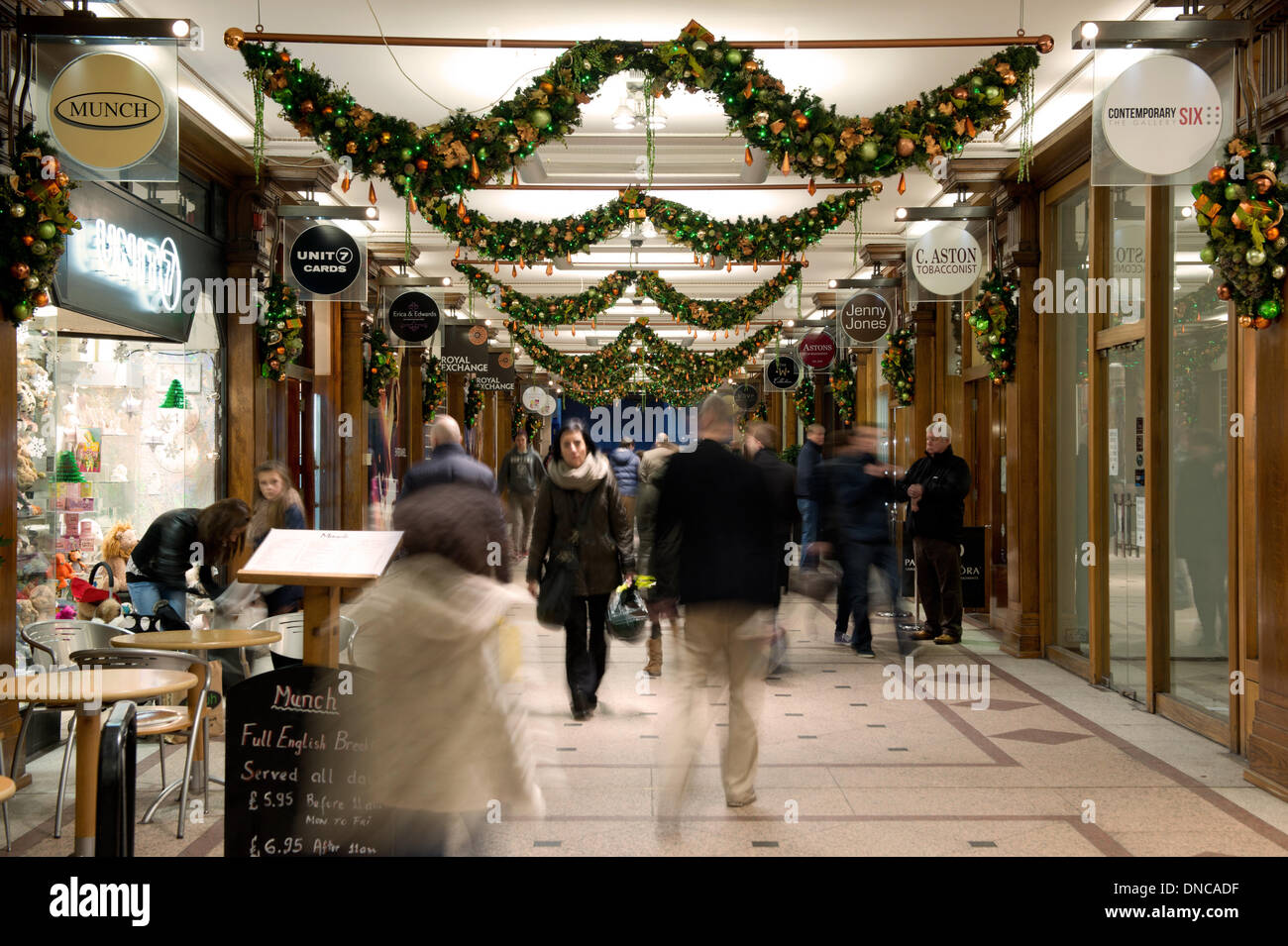 Manchester, UK. 22nd December, 2013. Christmas shoppers walk past independent stores in a small shopping mall during the lead up to the festive period. Both independent and chain stores attract customers in the lead up to the big day. Credit:  Russell Hart/Alamy Live News Stock Photo
