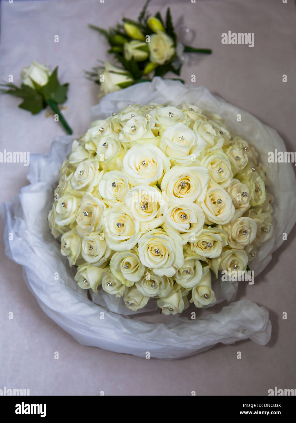 Brides wedding bouquet with button hole flowers Stock Photo